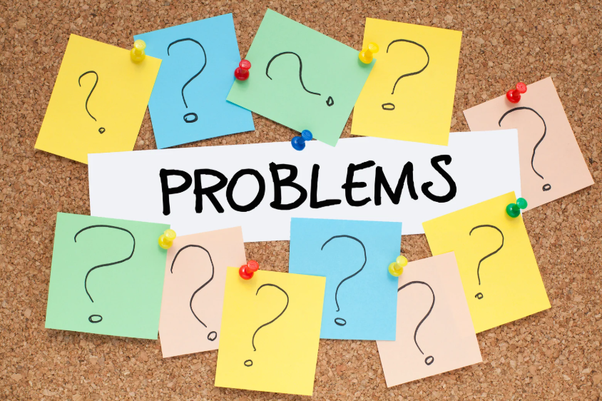Sticky notes with question marks showing questions to solve problems through clearer thinking.