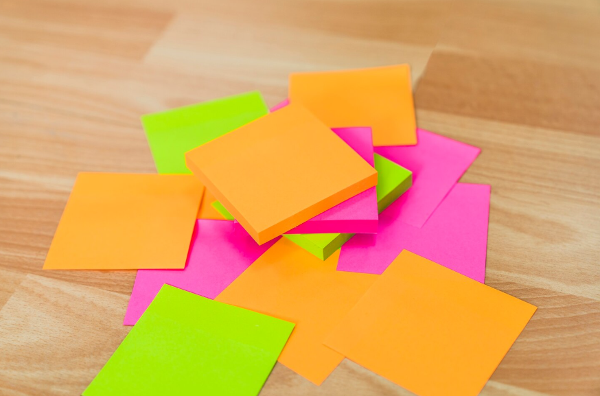 Colorful sticky notes showing everyday objects that inspired inventions through failed experiments.