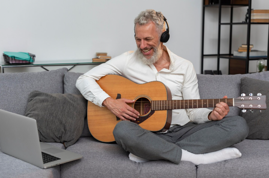 Older adult learning guitar at home as one of the hidden talents later in life discovered through hobbies.