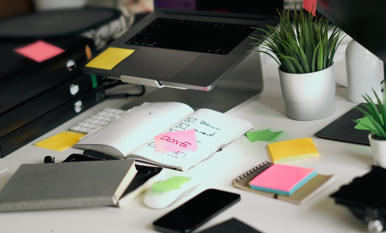 Desk with notebook and sticky notes showing a personal inspiration library for saving creative ideas.
