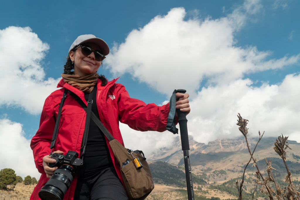 Woman hiking with a camera while learning how to find a hobby that fits her lifestyle.