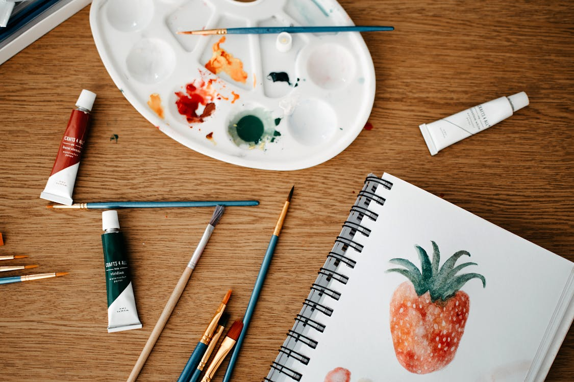 Sketchbook and limited paint colors showing how constraints improve creativity.