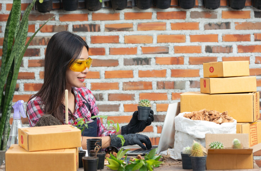 Woman packing small plants to show how to turn a hobby into a side project.